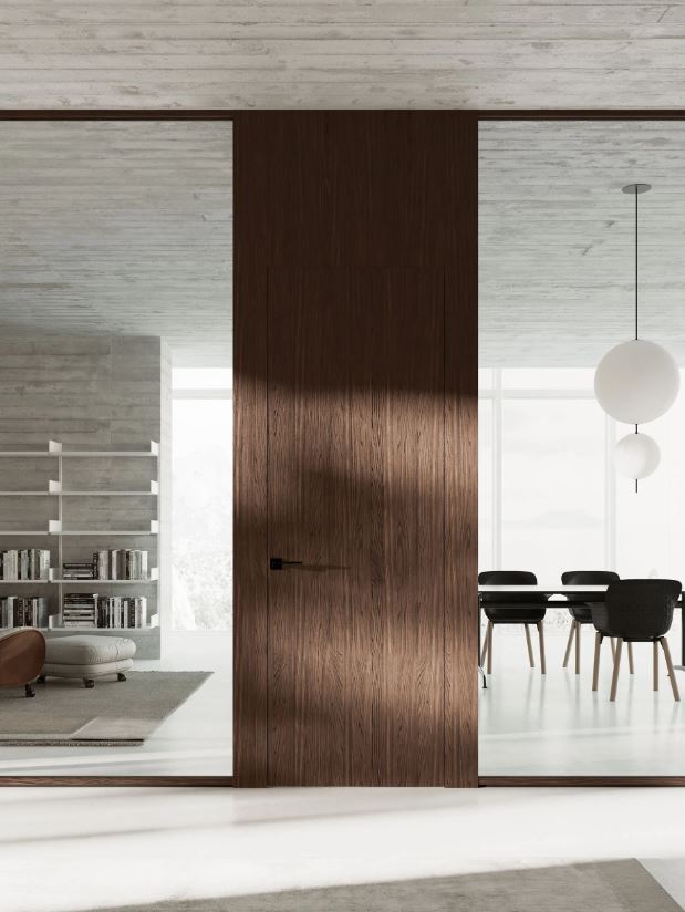 Modern interior with a wooden sliding door between two rooms.