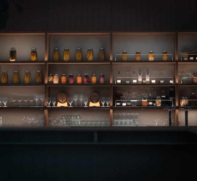 shelves-filled-with-glassware-and-jars-of-preserves